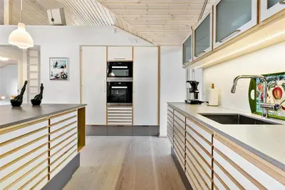a large kitchen with a sink and a stove at BL1733-Blokhus-Dahl-Iversensvej-5 in Blokhus