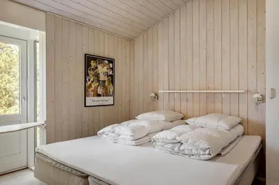 a bed with white blankets and pillows in a room at BL1386-Saltum-Kordalslien-7 in Saltum