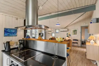 a kitchen with a stove top oven in a room at BL226-Blokhus-Paa-Bakken-13 in Blokhus