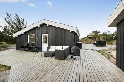 a wooden deck with a couch and chairs on it at BL332-Saltum-Svendborgvej-18 in Saltum