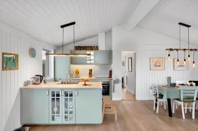 a kitchen with a table and a dining room at BL332-Saltum-Svendborgvej-18 in Saltum
