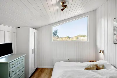 a bedroom with a bed and a window and a television at BL332-Saltum-Svendborgvej-18 in Saltum