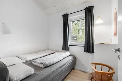 a room with two beds and a window at BL1266-Pandrup-Rodhusparken-58 in Pandrup