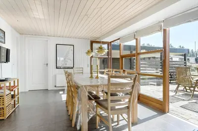 a dining room with a table and chairs at BL789-Blokhus-Pirupshvarrevej-20 in Blokhus