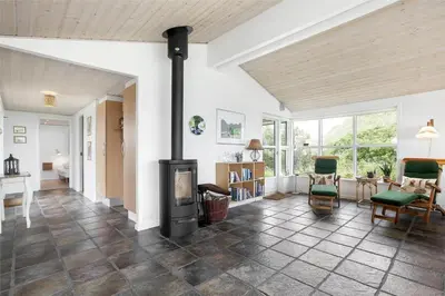 a living room with a wood burning stove in it at BL216-Saltum-Svendborgvej-25 in Saltum