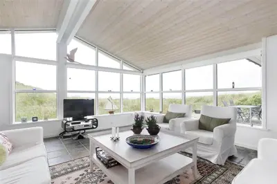 a living room with white furniture and large windows at BL216-Saltum-Svendborgvej-25 in Saltum