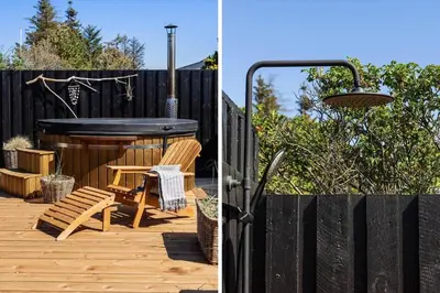 a backyard with a hot tub and a wooden deck at BL1640-Blokhus-Solbakkevej-2 in Blokhus