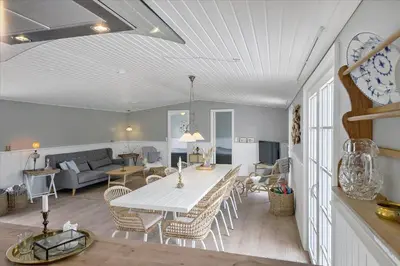 a living room with a white table and chairs at BL1640-Blokhus-Solbakkevej-2 in Blokhus
