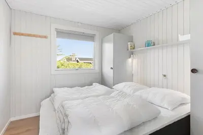 a bedroom with a large white bed with a window at BL1326-Saltum-Svendborgvej-19 in Saltum
