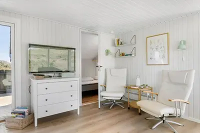 a room with two chairs and a desk and a television at BL1326-Saltum-Svendborgvej-19 in Saltum