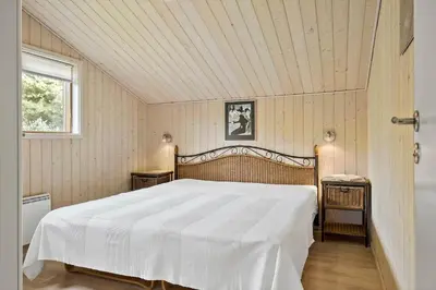 a bedroom with a large white bed in a room at BL100-Blokhus-Morten-Nielsensvej-19 in Blokhus