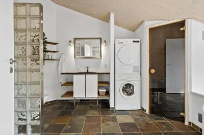 a laundry room with a washing machine and a counter at BL100-Blokhus-Morten-Nielsensvej-19 in Blokhus