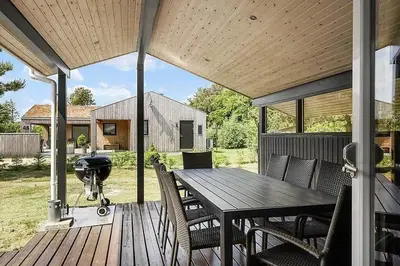 a patio with a grill and a table and chairs at BL257-Pandrup-Rodhus-Skolevej-44 in Pandrup