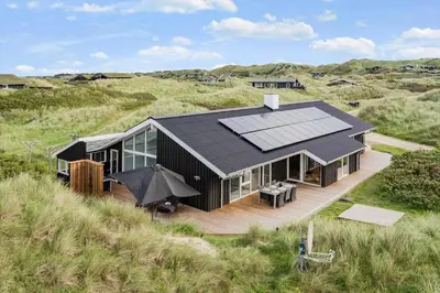 an overhead view of a black house on a beach at BL119-Blokhus-Egebaeksvej-20 in Blokhus
