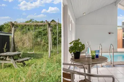 a patio with a table and a picnic table at BL119-Blokhus-Egebaeksvej-20 in Blokhus