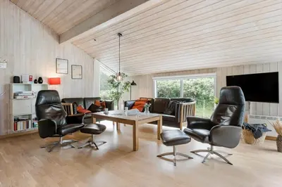 a living room with leather chairs and a table at BL119-Blokhus-Egebaeksvej-20 in Blokhus