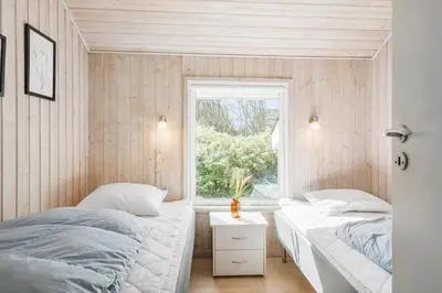 two beds in a small room with a window at BL119-Blokhus-Egebaeksvej-20 in Blokhus