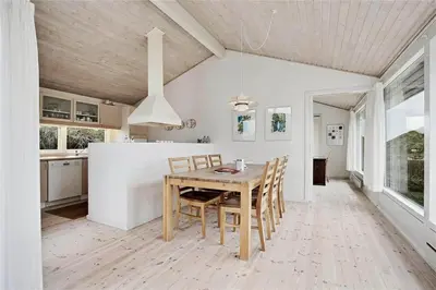 a kitchen and dining room with a table and chairs at BL358-Pandrup-Kaskelotten-5 in Pandrup