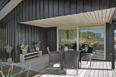 a patio with a table and chairs on a deck at BL867-Saltum-Karen-Mariesvej-48 in Saltum