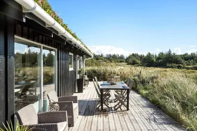a deck with a table and chairs on a house at BL867-Saltum-Karen-Mariesvej-48 in Saltum