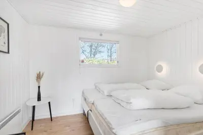 a white bedroom with a bed and a window at BL867-Saltum-Karen-Mariesvej-48 in Saltum