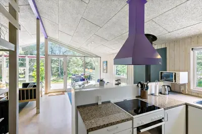 a kitchen with a purple chandelier hanging from the ceiling at BL609-Pandrup-Rodhus-Skolevej-10 in Pandrup