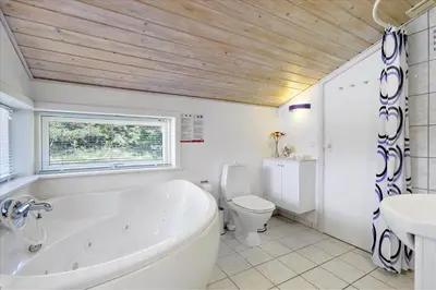 a bathroom with a tub and a toilet and a sink at BL609-Pandrup-Rodhus-Skolevej-10 in Pandrup