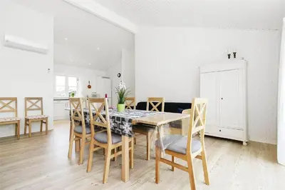 a kitchen and dining room with a table and chairs at BL386-Saltum-Nordvestvej-13 in Saltum