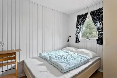 a bed in a white room with a window at BL380-Pandrup-Rodhus-Skolevej-1 in Pandrup