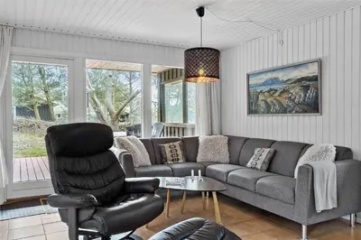 a living room with a couch and a chair at BL380-Pandrup-Rodhus-Skolevej-1 in Pandrup
