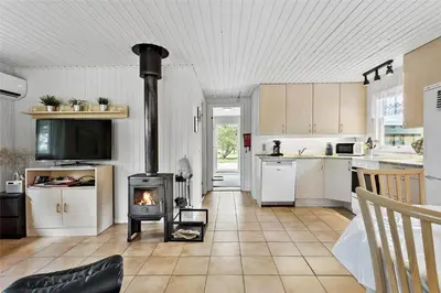 a kitchen with a stove in the middle of a room at BL380-Pandrup-Rodhus-Skolevej-1 in Pandrup