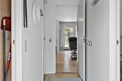 a hallway with a black chair in a room at BL380-Pandrup-Rodhus-Skolevej-1 in Pandrup