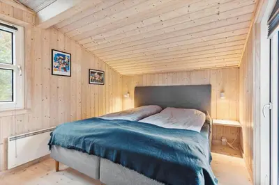 a bed in a small room with a wooden ceiling at BL1227-Saltum-Porsevej-31 in Saltum