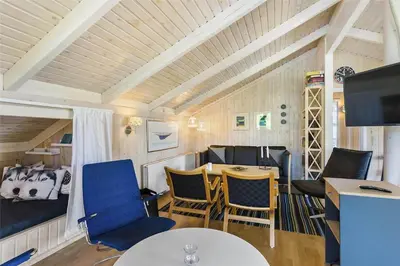 a living room with blue chairs and a table at BL201-Saltum-Kalundborgvej-21 in Saltum