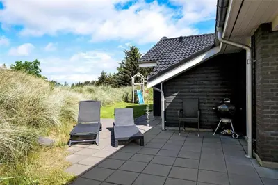 a group of chairs sitting on a patio at BL417-Blokhus-Saetergaardsstien-6-A in Blokhus