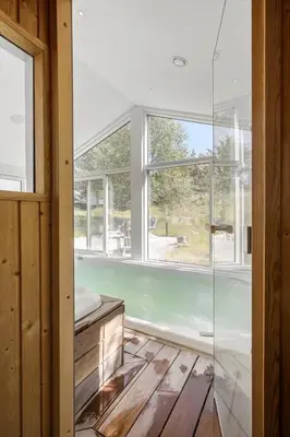 a glass shower in a room with a window at BL1777-Blokhus-Lyngbakkevej-10 in Blokhus