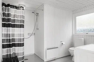 a bathroom with a toilet and a shower curtain at BL1770-Saltum-Klittornvej-5 in Saltum