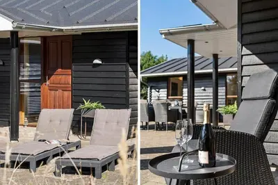 a patio with a table and chairs and a house at BL1718-Blokhus-Ronliensvej-16 in Blokhus