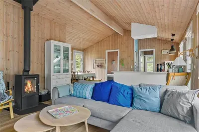 a living room with a couch and a fireplace at BL1627-Blokhus-Lyngvej-17 in Blokhus