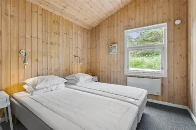 a bedroom with two beds and a window at BL1627-Blokhus-Lyngvej-17 in Blokhus