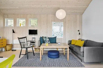 a living room with a couch and a table at BL809-Pandrup-Lommelaerken-20 in Pandrup