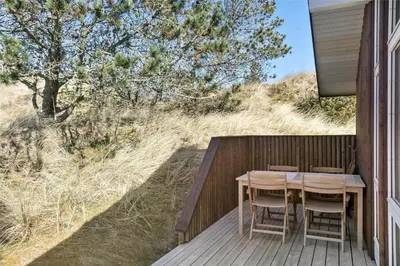 a wooden deck with a table and chairs on it at BL809-Pandrup-Lommelaerken-20 in Pandrup