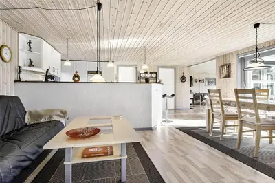 a living room with a couch and a table at BL613-Blokhus-Septimusvej-9 in Blokhus