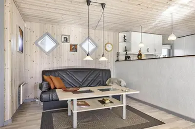 a living room with a couch and a table at BL613-Blokhus-Septimusvej-9 in Blokhus