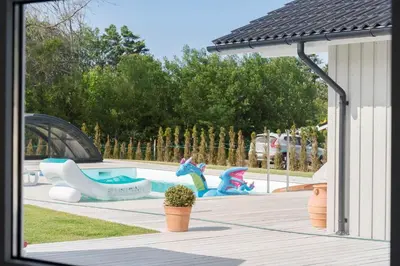 a swimming pool with statues of unicorns in a park at BL1477-Blokhus-Park-Alle-5 in Blokhus
