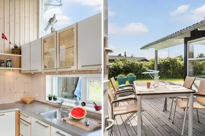 a kitchen and dining area with a table and chairs at BL935-Blokhus-Tobaksvej-1 in Blokhus