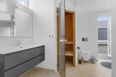 a bathroom with a sink and a toilet at BL234-Blokhus-Sdr-Strandvej-9-A in Blokhus