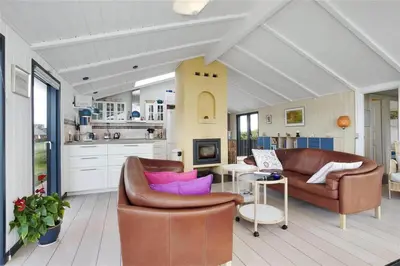 a living room with two leather chairs and a table at BL441-Pandrup-Sydvej-14 in Pandrup