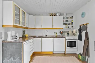 a kitchen with white cabinets and white appliances at BL1580-Saltum-Kohlsvej-17 in Saltum