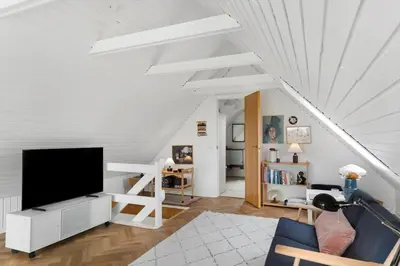 a living room with a flat screen tv on a white wall at BL1580-Saltum-Kohlsvej-17 in Saltum